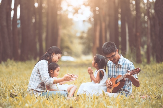 Happy family father playing guitar