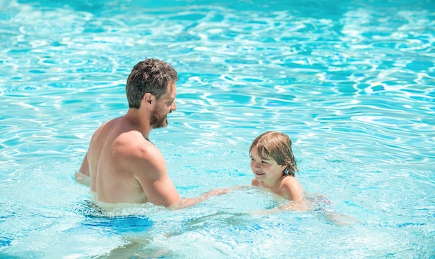 Happy family of father and son boy having fun in summer swimming pool family