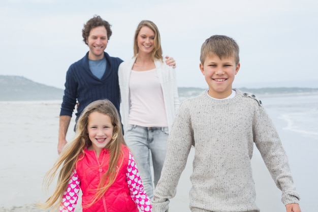 Famiglia felice di quattro in spiaggia