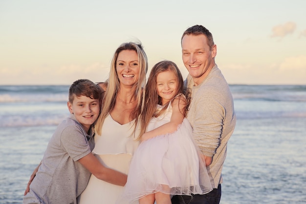 Happy Family of four portrait on the beach