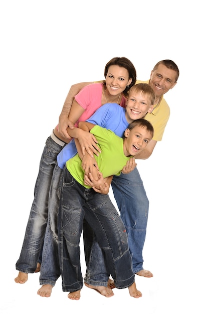 Happy family of four standing on white background