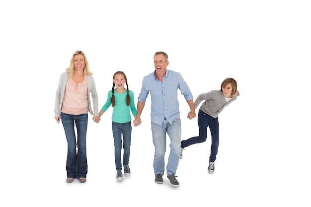 Happy family of four walking hand in hand