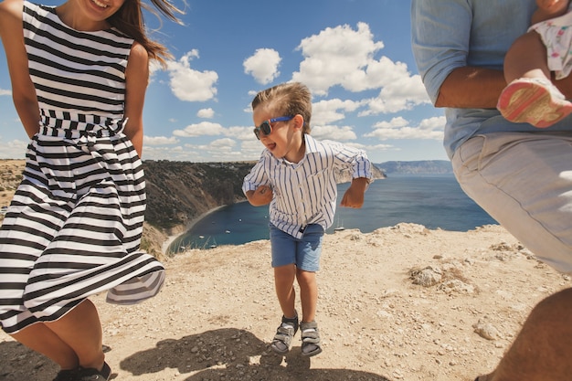 Happy family of four walking in the mountains. Family concept. Family trip.