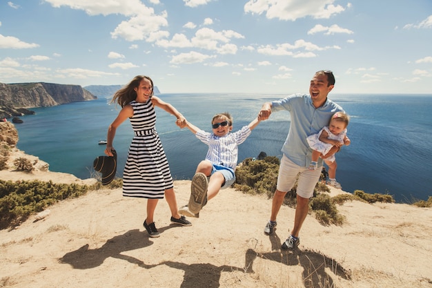 Happy family of four walking in the mountains