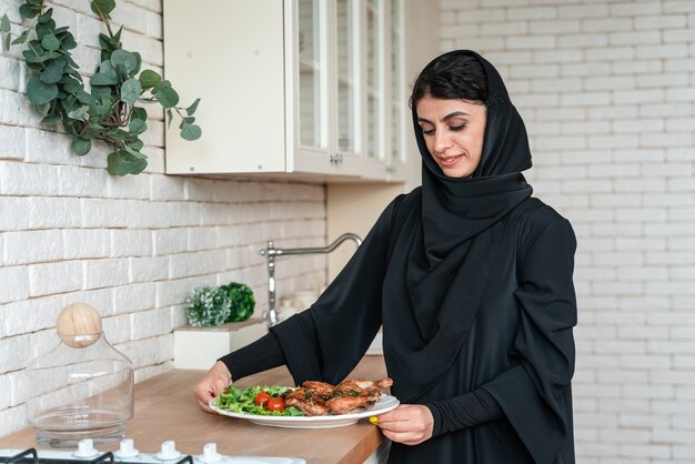 Happy family from arab united emirates eating together and celebrating the national day holidays