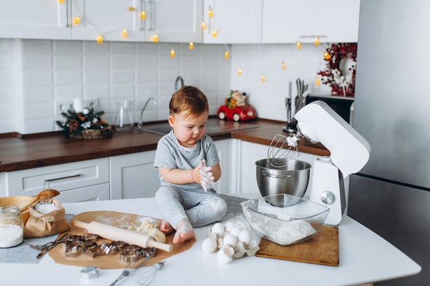 Happy family funny boy preparing the dough, bake cookies in the kitchen