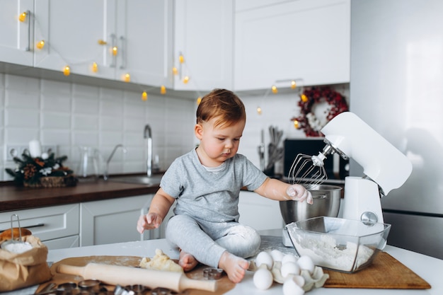 Happy family funny boy preparing the dough, bake cookies in the kitchen