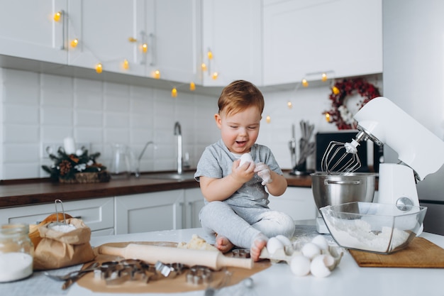 Happy family funny boy preparing the dough, bake cookies in the kitchen