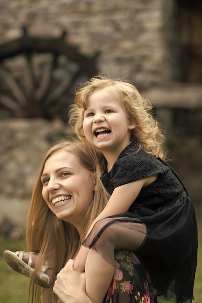 Happy family Girl child smile on woman shoulders