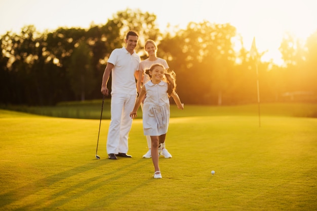 Happy Family of Golfers on Course Joyful Players.