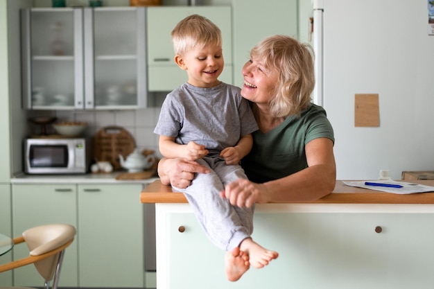 Happy family grand mother hugs with grandson at home