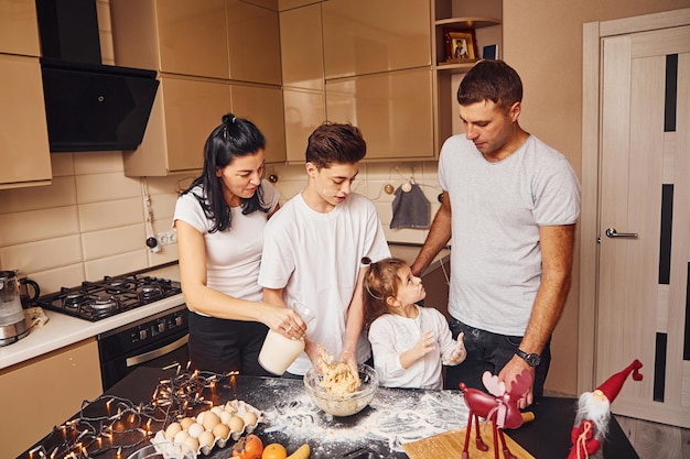 Happy family have fun on the kitchen and preparing food.