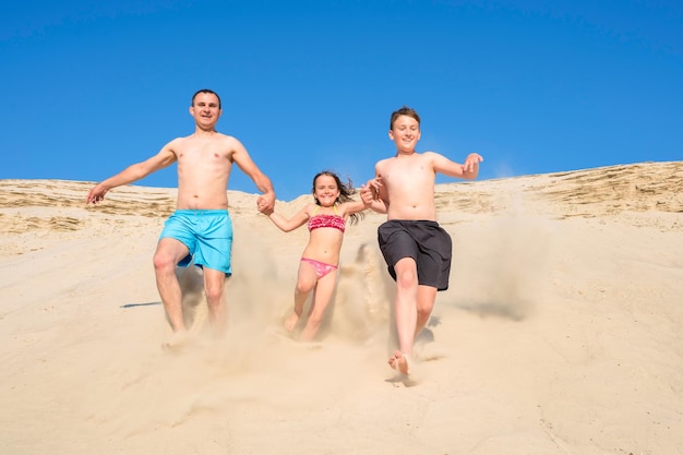 Happy family have fun playing on summer vacation sports recreation vacations