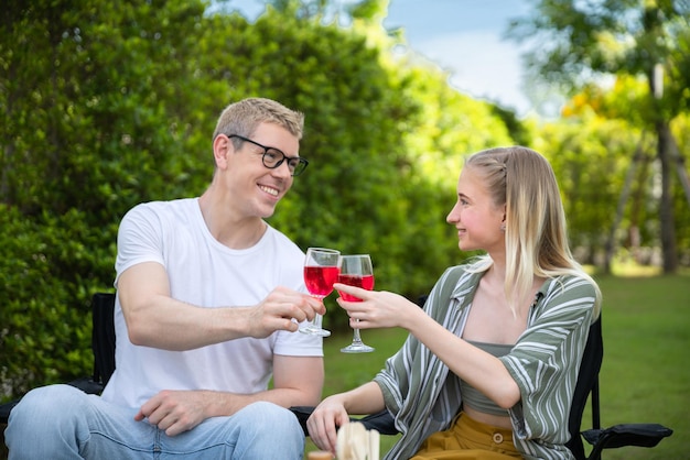 Happy family having barbecue bbq party with red wine in outdoor backyard garden of house with happy