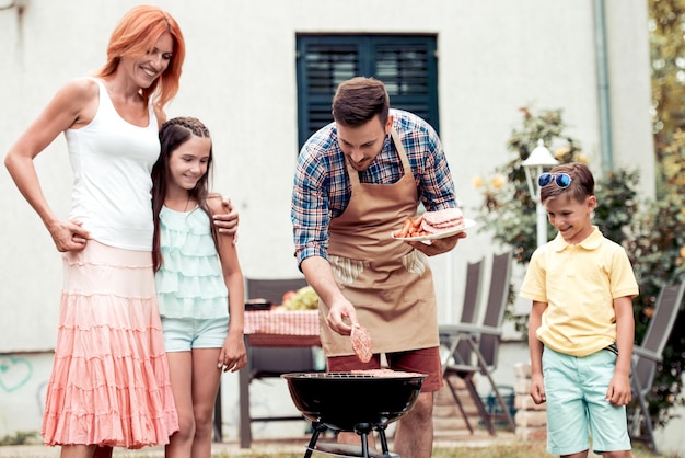 Happy family having barbecue