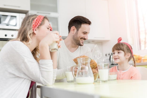 Happy family having breakfast at home