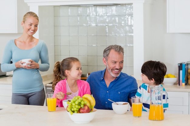 Happy family having breakfast in kitchen