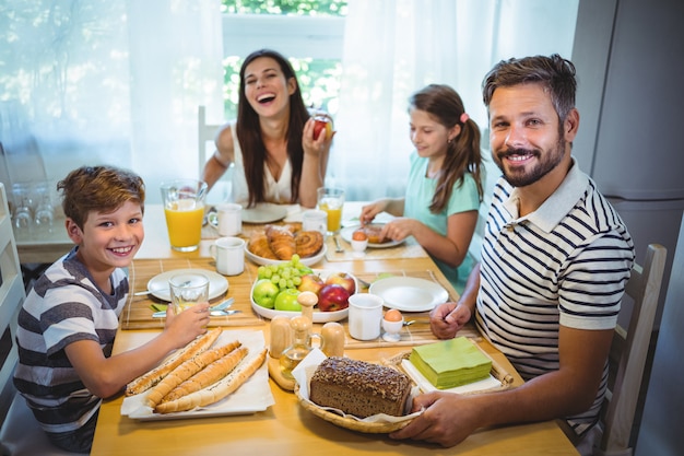 Happy family having breakfast together