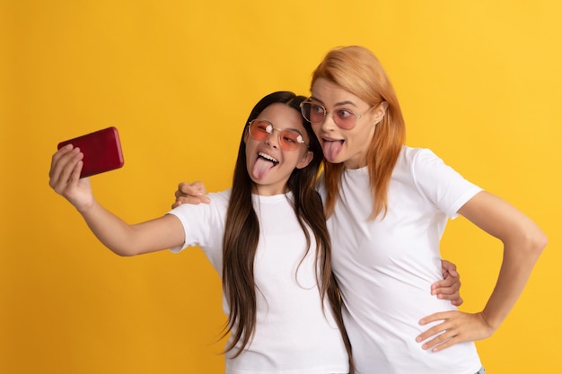 Happy family having fun mom and kid making selfie on smartphone childhood