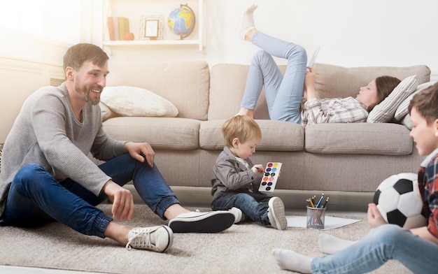 Happy family having fun and resting together on sofa at home