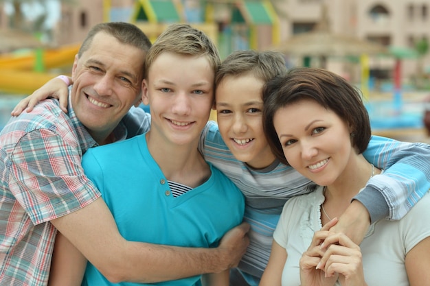 Photo happy family having fun at tropical resort near pool.