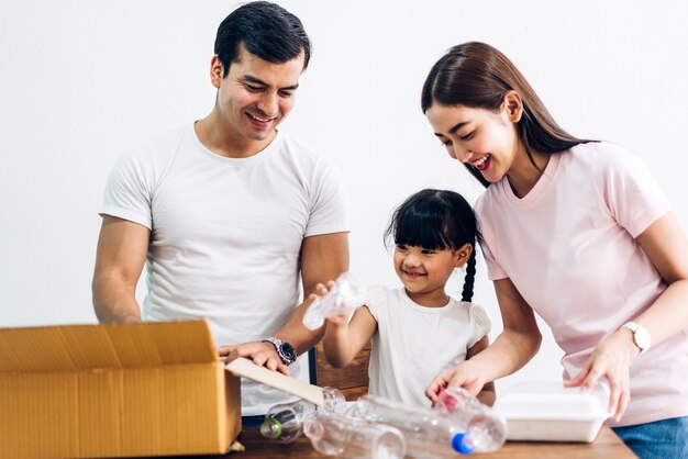 Happy family having fun using recycle box