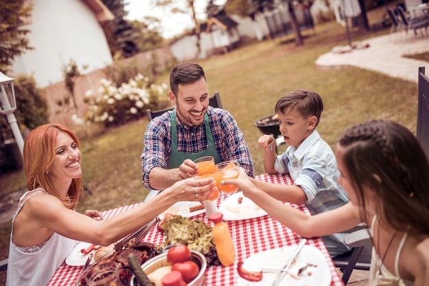 Happy family having lunch in the garden