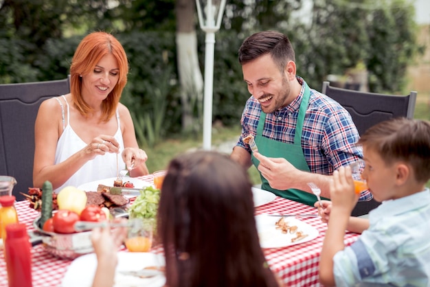 Happy family having lunch in garden