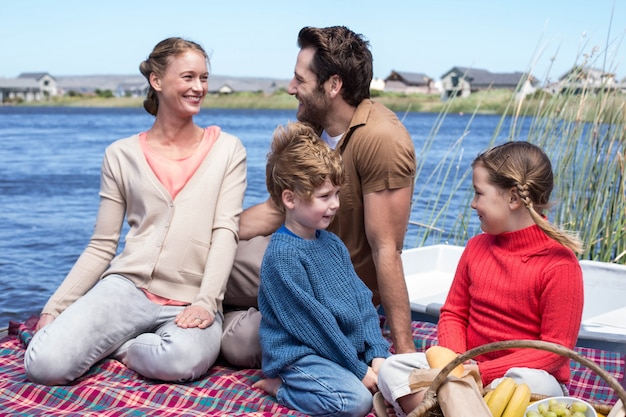 Happy family having picnic at a lake