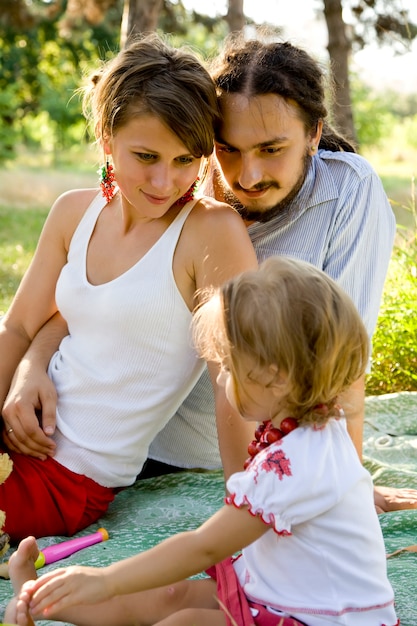 Happy family having picnic in summer park