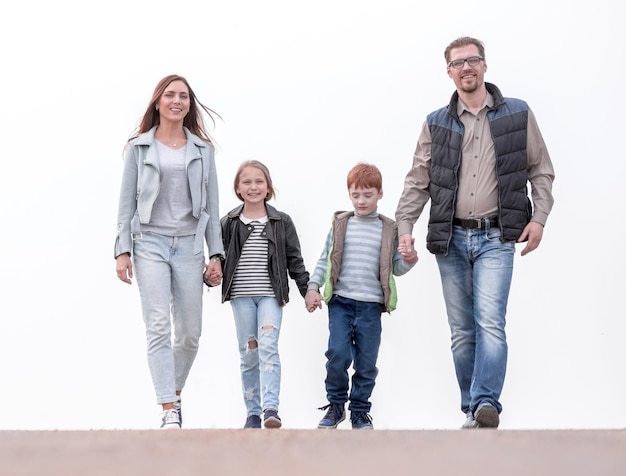 Happy family holding hands and walking