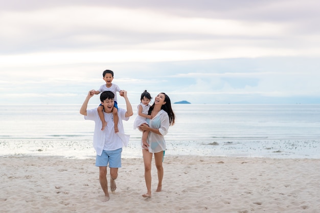 Happy family holidays during joyful father, mother, son and daughter walking together