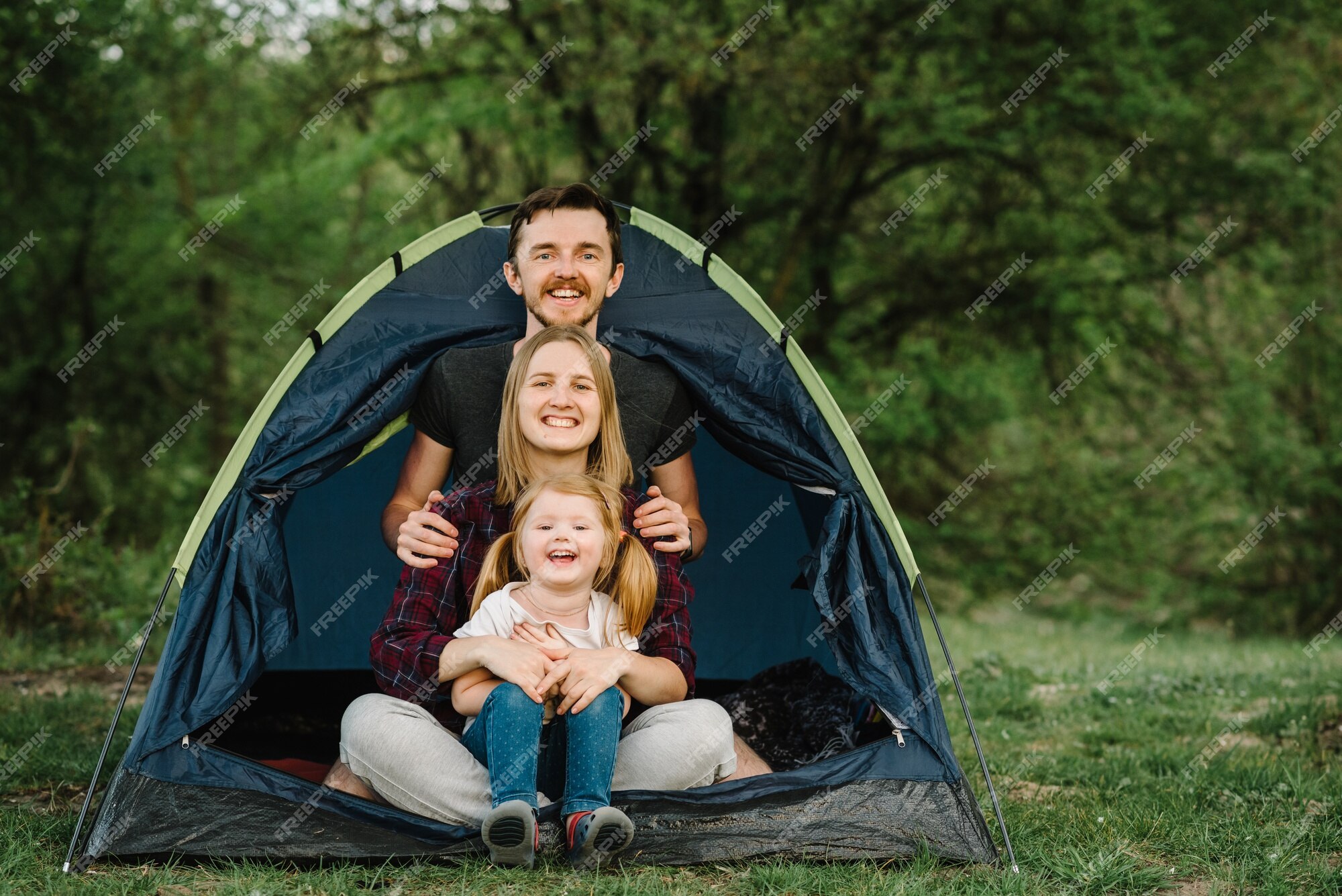 Sisters spending time in a tent on camping. Children using tablet playing games  online during summer vacation - a Royalty Free Stock Photo from Photocase