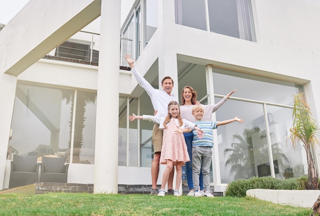 Happy family and home investment real estate of people that celebrate new property outdoor Man realtor mother and children with happiness smile and a love for a house with excited kids and parent