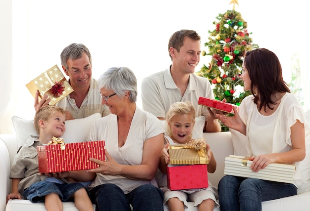 Happy family at home opening Christmas presents