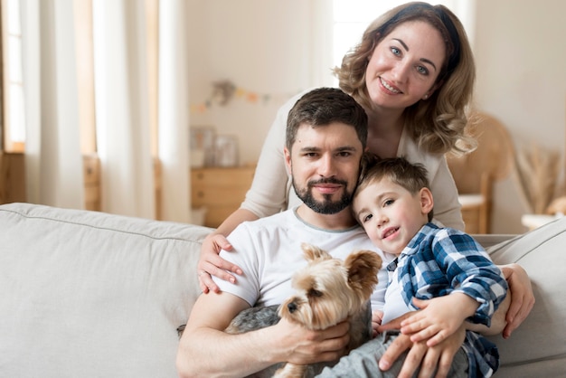 Photo happy family indoors with cute dog