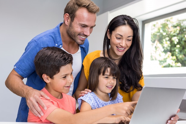 Happy family interacting using laptop