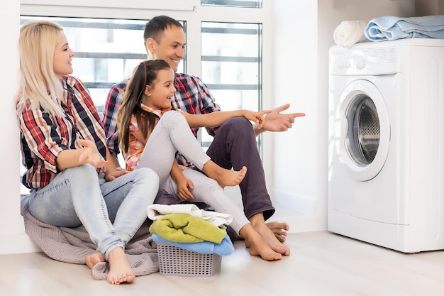 Happy family is doing the laundry