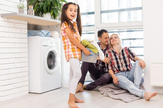 Happy family is doing the laundry