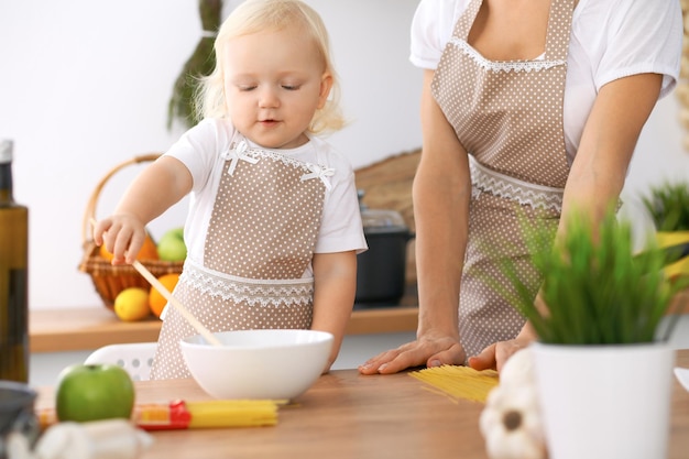 Photo happy family in the kitchen. mother and child daughter  cooking tasty breakfest