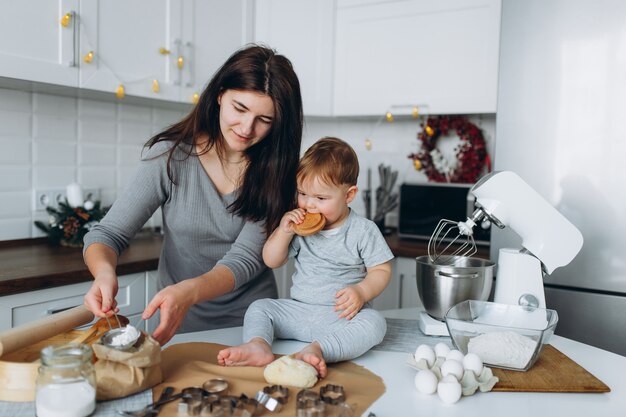 Happy family in the kitchen. mother and son preparing the dough, bake cookies