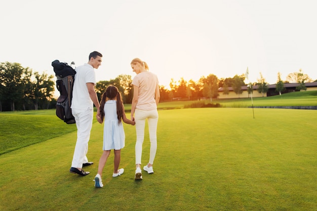 Happy Family Leaves the Golf Field after Game.