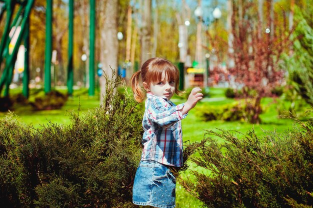 Happy family lifestyle and holiday concept. mother, father,\
little girl walking in city, green park