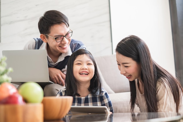 Happy family looking at digital tablet