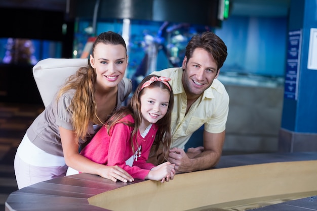 Happy family looking at fish tank