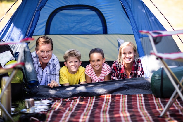 Happy family lying in a tent