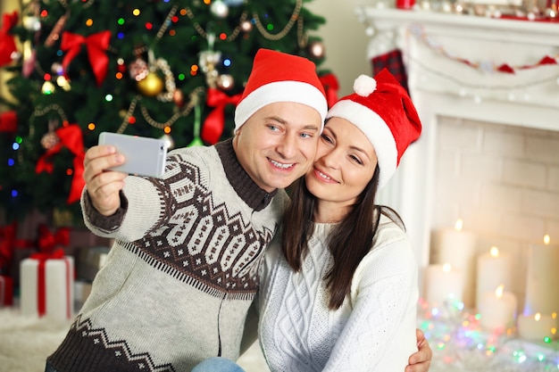 Happy Family making photo on Christmas tree