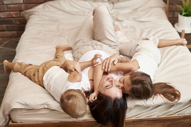 Happy family. Mom hugs son and daughter