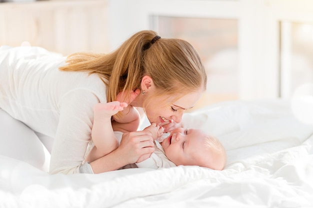 Happy family mother in bed with newborn baby