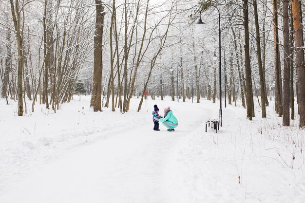 Happy family. Mother and child girl on a winter walk in nature.